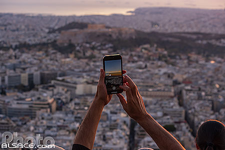 Photo : Touriste faisant une photo au smartphone depuis le mont Lycabette, Athènes, Grèce
